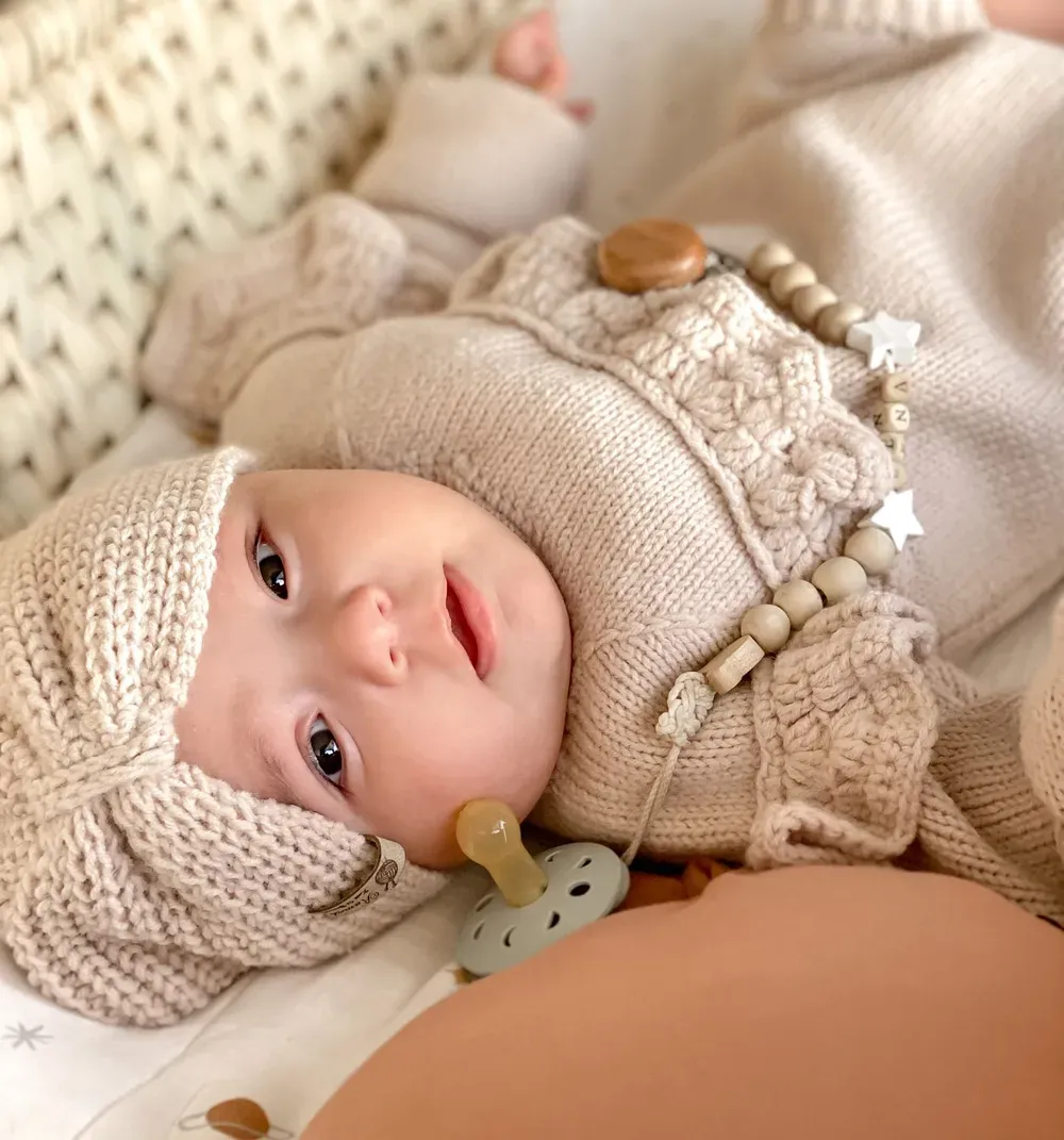 A baby resting in a sunlit nursery